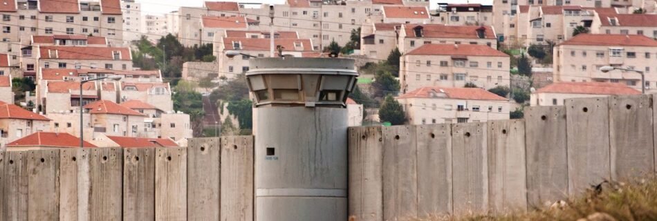 Ryan Rodrick Beiler The Separation Wall in the Occupied Palestinian Territory and behind it an Israeli settlement.